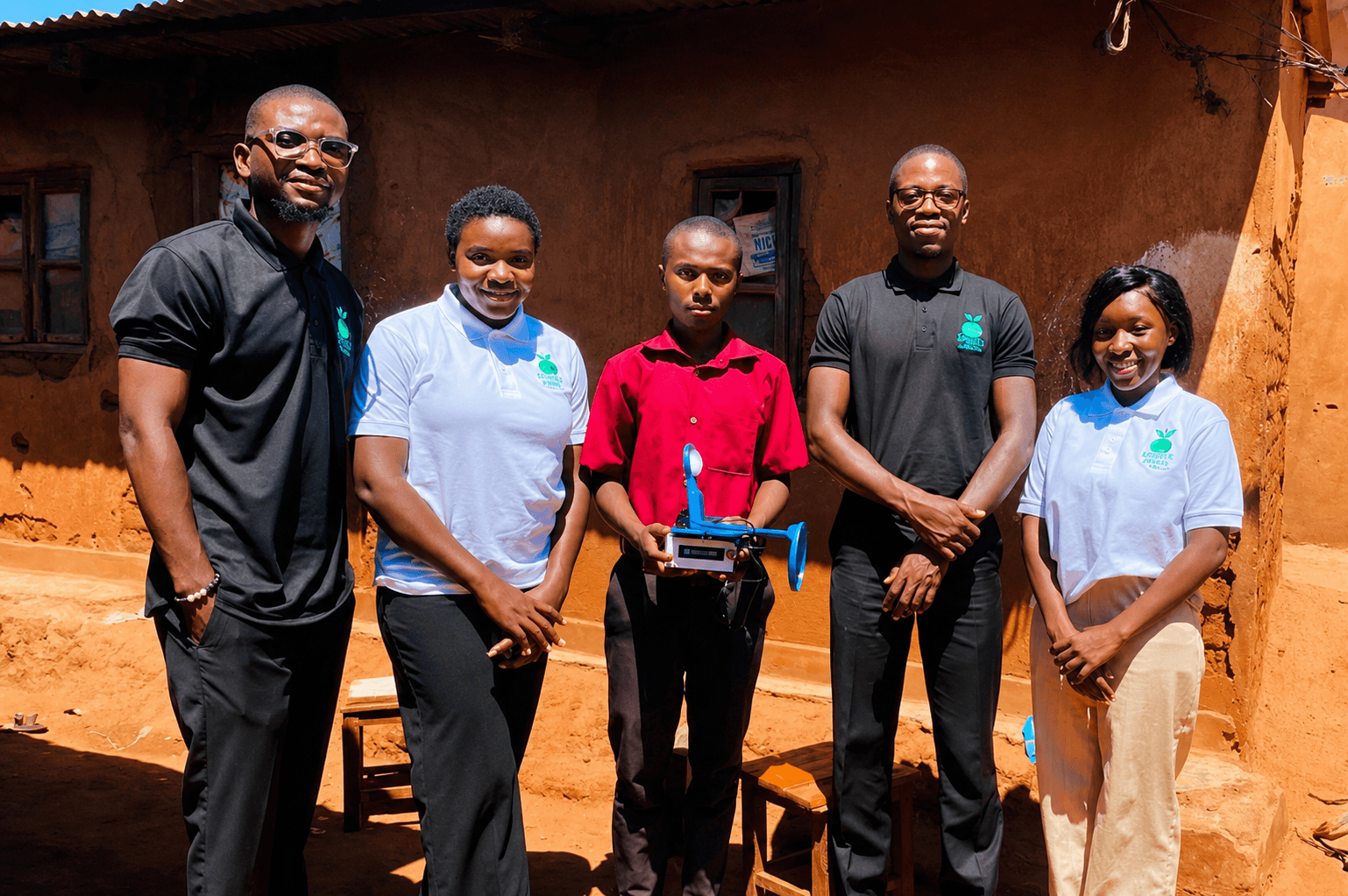 Lucky Sikelo receives his solar lamp from the Green Minds team